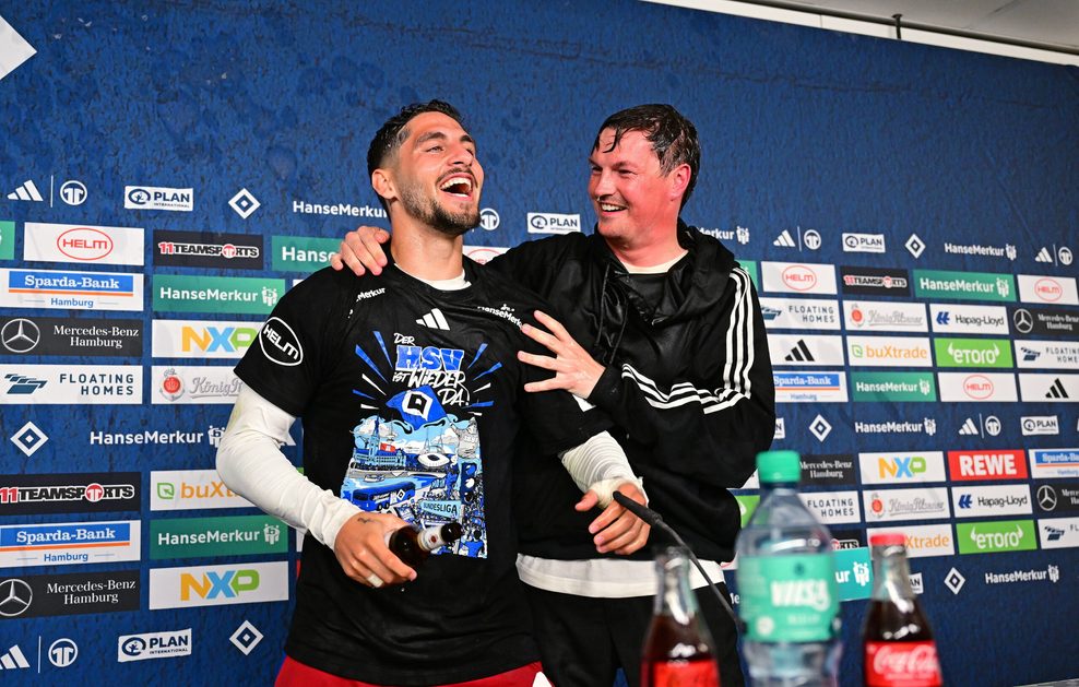 Merlin Polzin umarmt Ludovit Reis auf dem PK-Podium