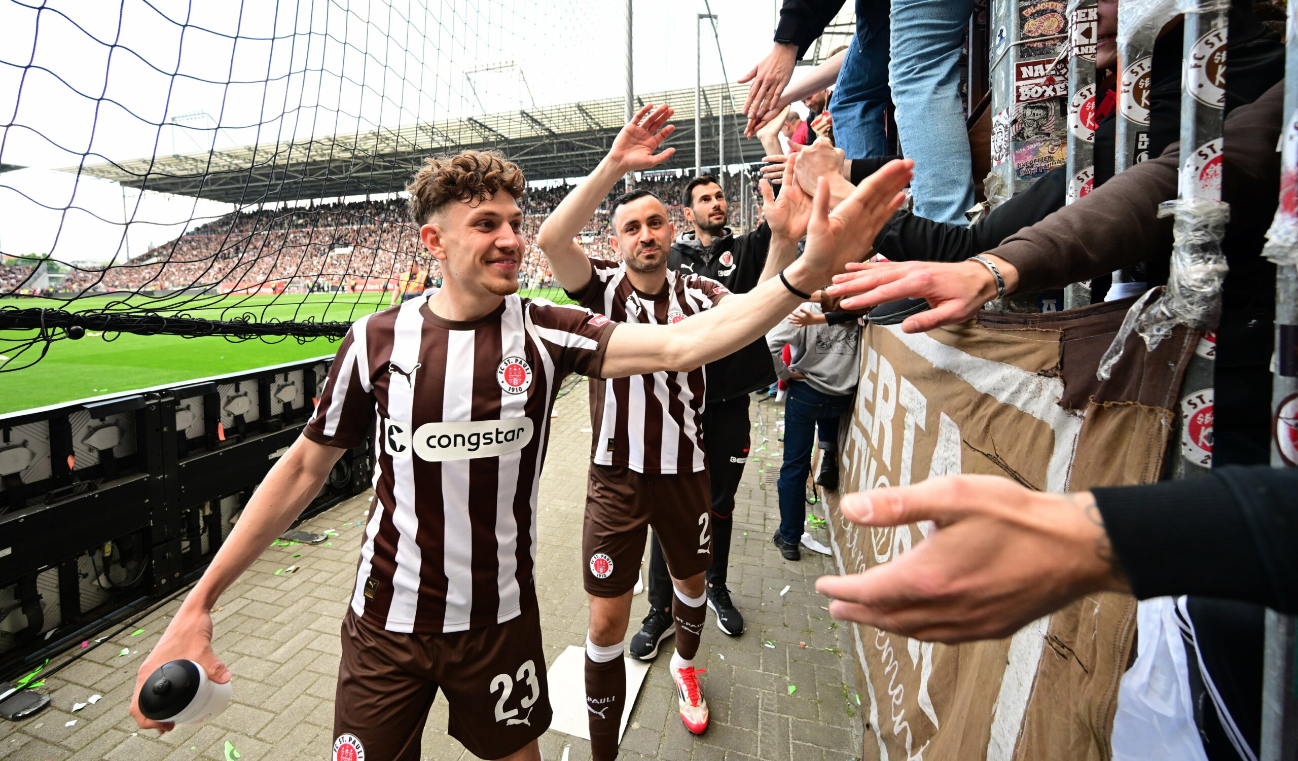 Philipp Treu und Manolis Saliakas klatschen mit den Fans ab