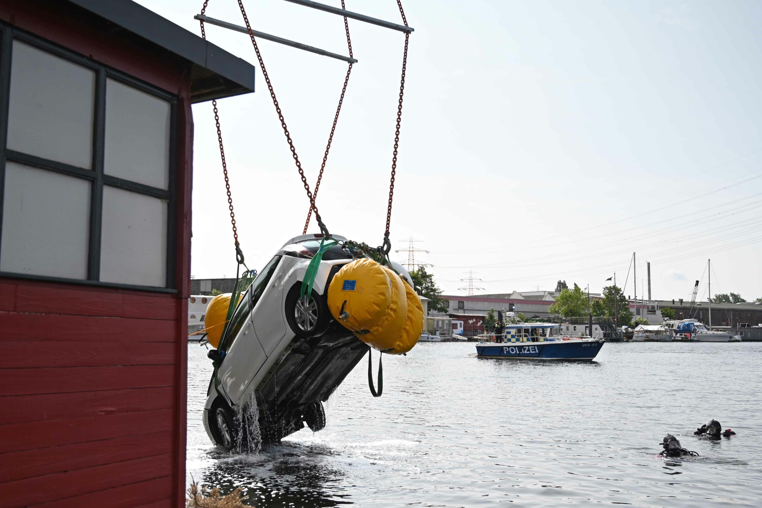 PKW rollt in Harburger Hafenbecken – Kran hebt Kleinwagen aus dem Wasser und über Bäume