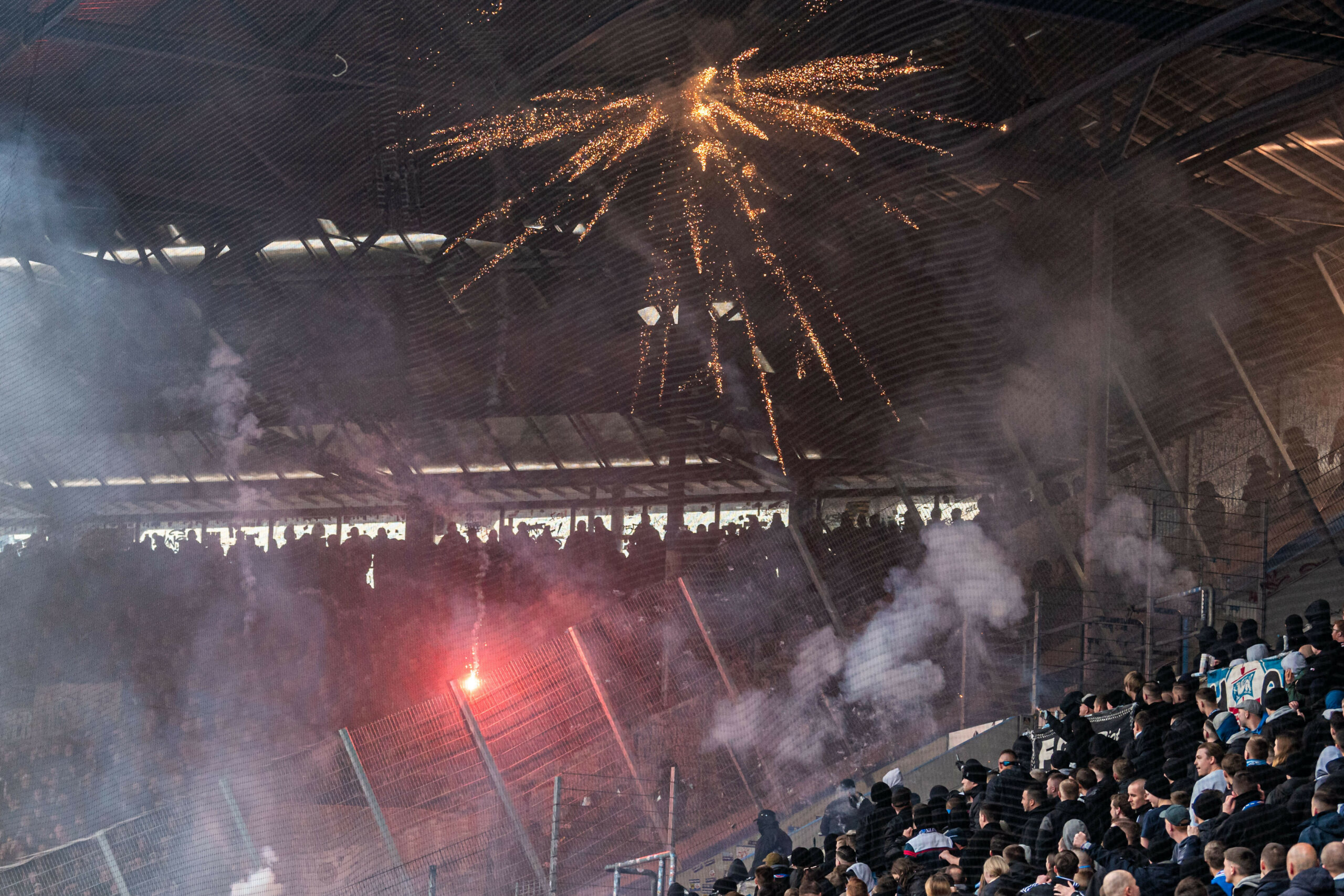 Fans von Hansa Rostock schießen Pyrotechnik in den Dresdner Gästeblock