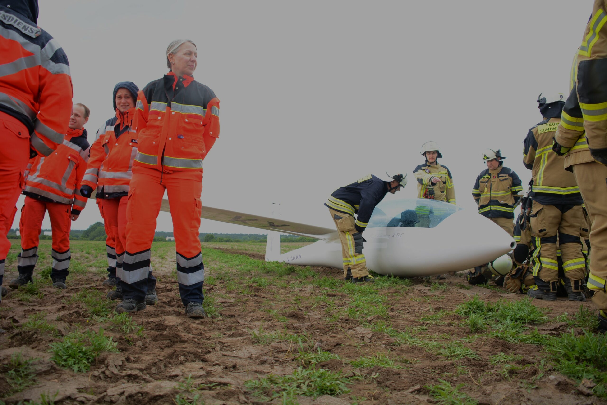 Ein Flieger und Rettungskräfte auf einem Acker