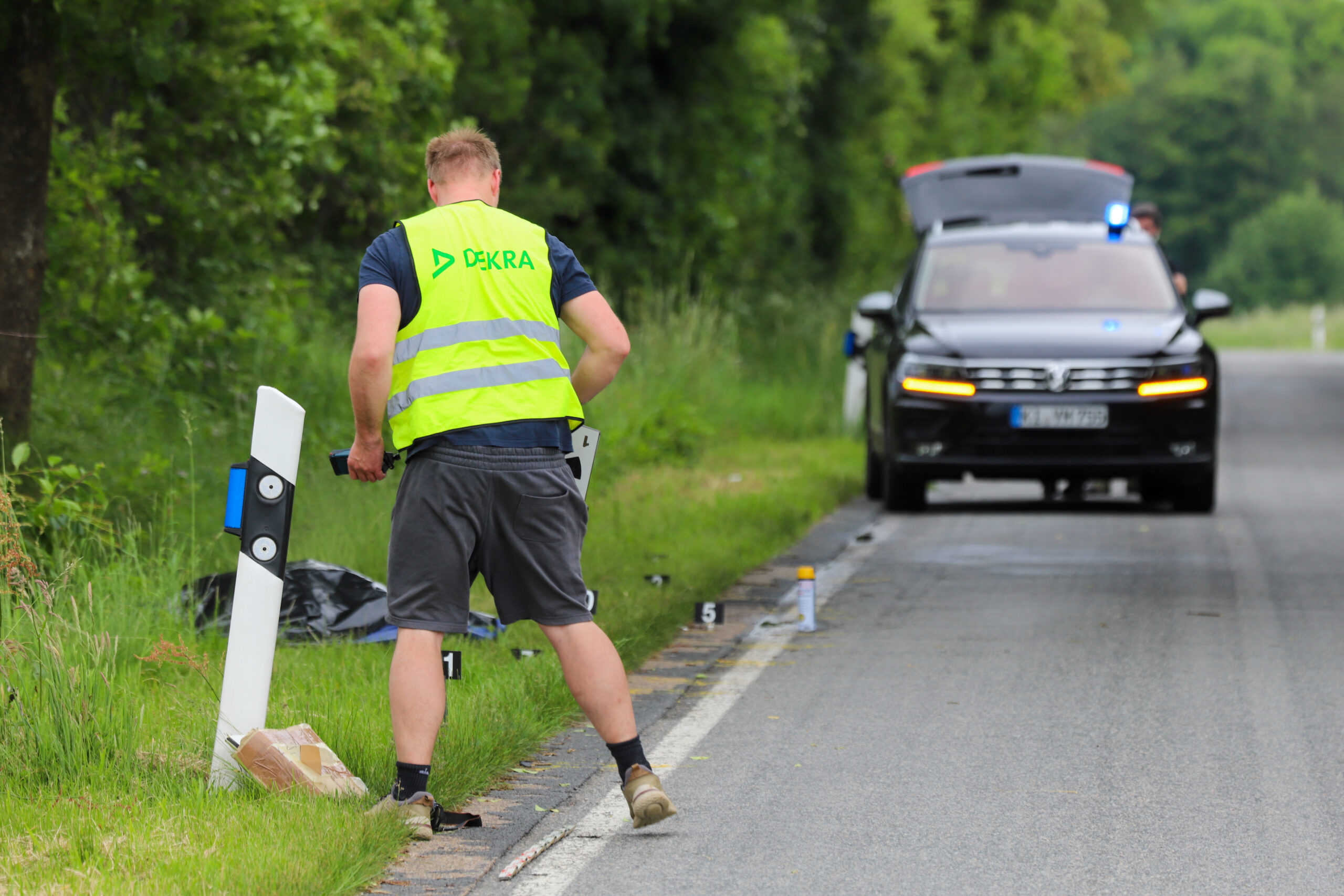 Ein Dekra-Gutachter sucht die Unfallstelle nach Hinweisen ab.