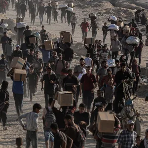 Palästinenser tragen Lebensmittelpakete, die von der The Gaza Humanitarian Foundation (GHF) in Gaza-Stadt verteilt wurden.