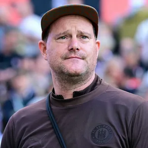 Oke Göttlich schaut leicht nach oben und grinst