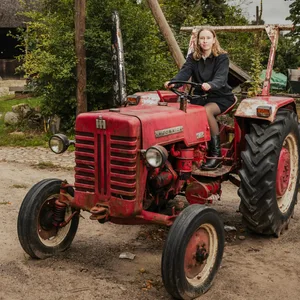 MOPO Reporterin Emilia Skibbe sitzt auf einem roten Traktor.