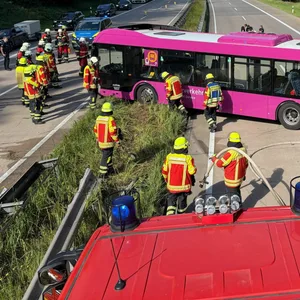 Pinker Bus steht quer auf Autobahn