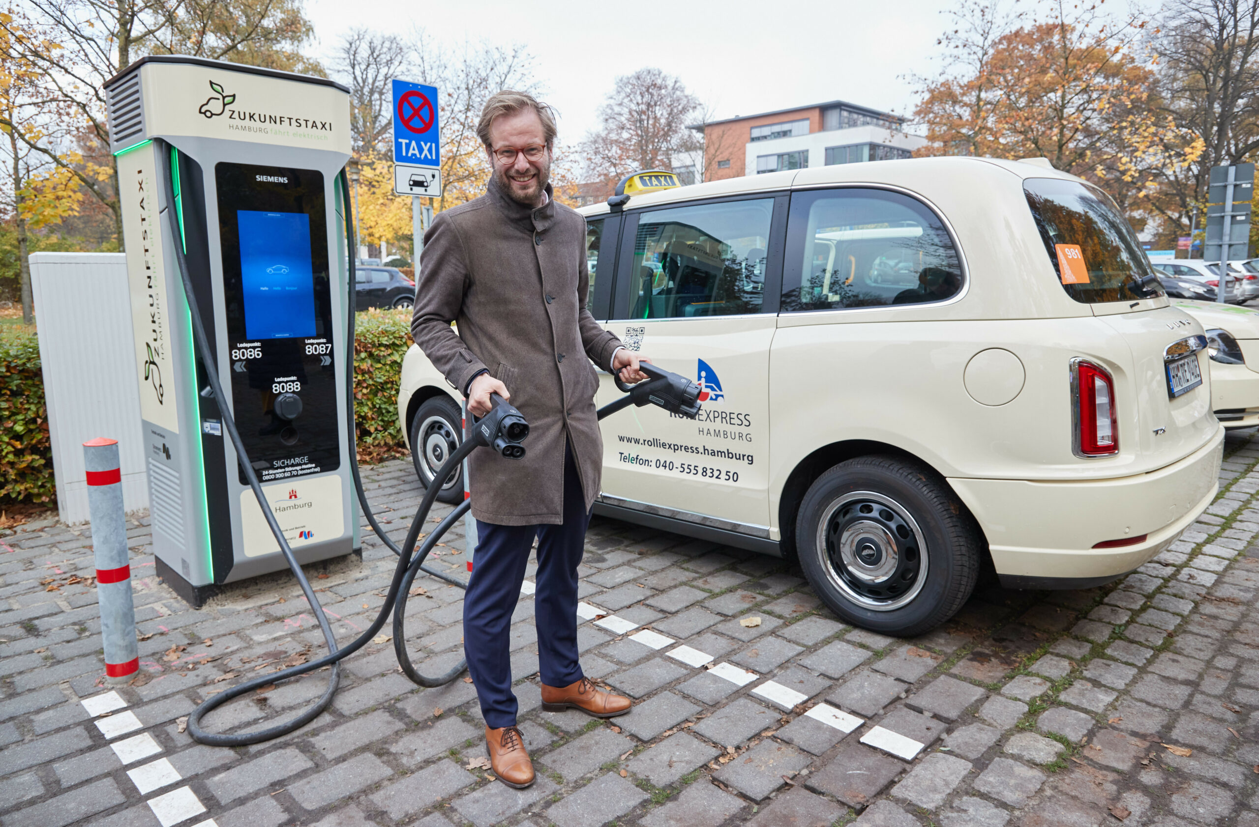 Hamburgs Verkehrssenator Anjes Tjarks (Grüne) steht an einem Ladestand für Elektro-Taxis am Alsterdorfer Markt (Archivbild).