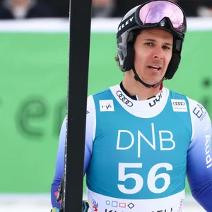 Matteo Franzoso mit seinen Skiern in der Hand.