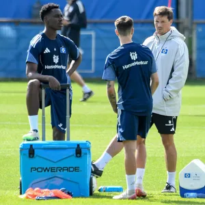 Merlin Polzin spricht im HSV-Training mit Albert Sambi Lokonga und Fabio Vieira