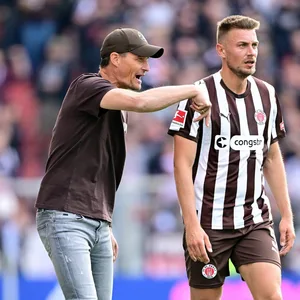 Alexander Blessin gibt Hauke Wahl Anweisungen im Spiel gegen Augsburg.