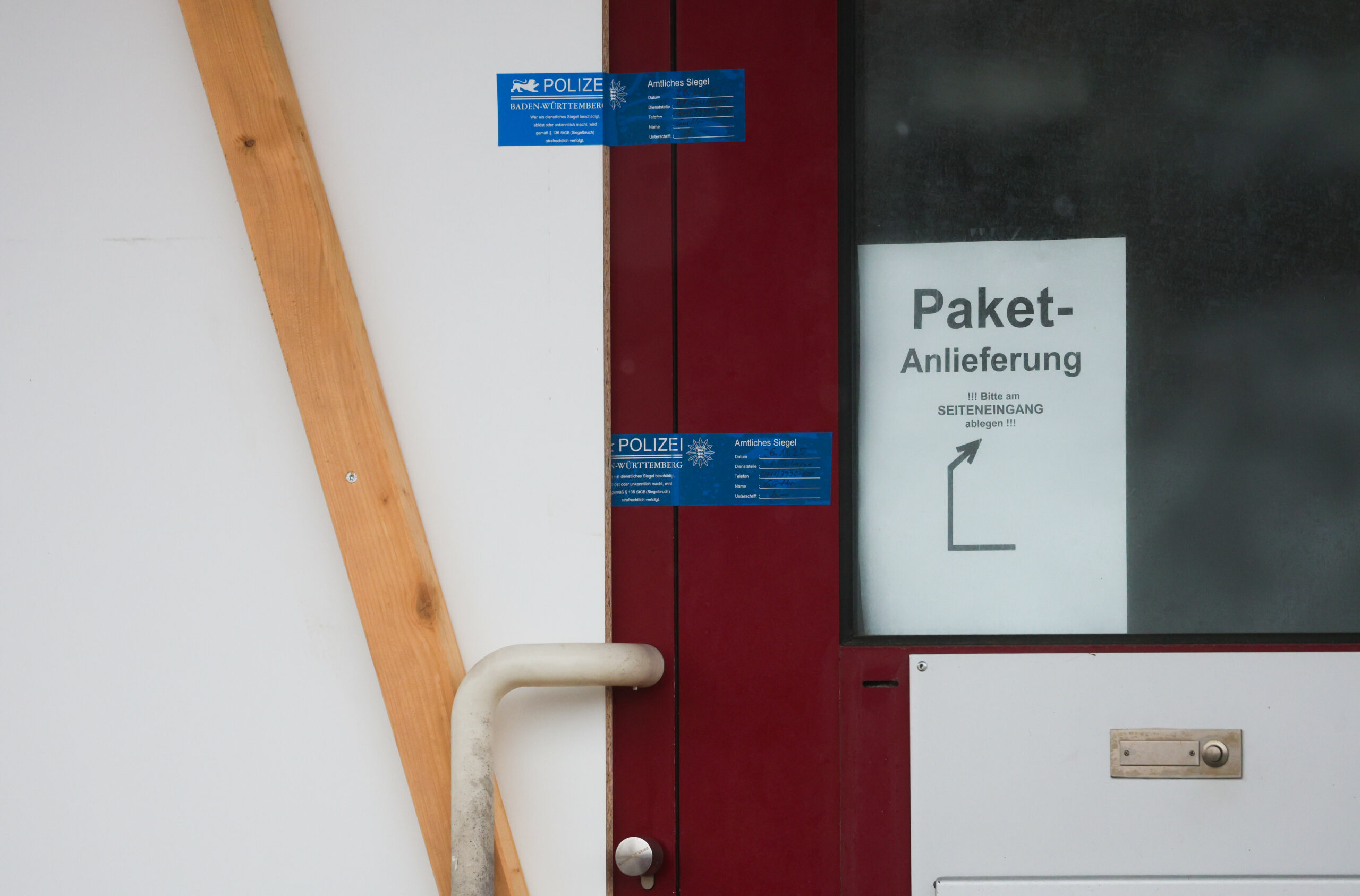 Polizei-Siegel sind an der Eingangstüre einer Firma zu sehen. Ein Mann soll im Großraum Reutlingen in Baden-Württemberg vier Menschen und dann sich selbst getötet haben.