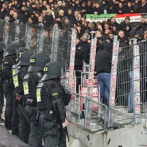 Polizisten stehen vor dem Gästeblock in Stuttgart und beobachten die Fans von Feyenoord Rotterdam
