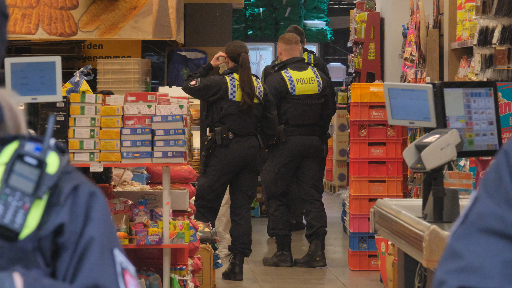 Mehrere Beamte stehen in einem Laden.