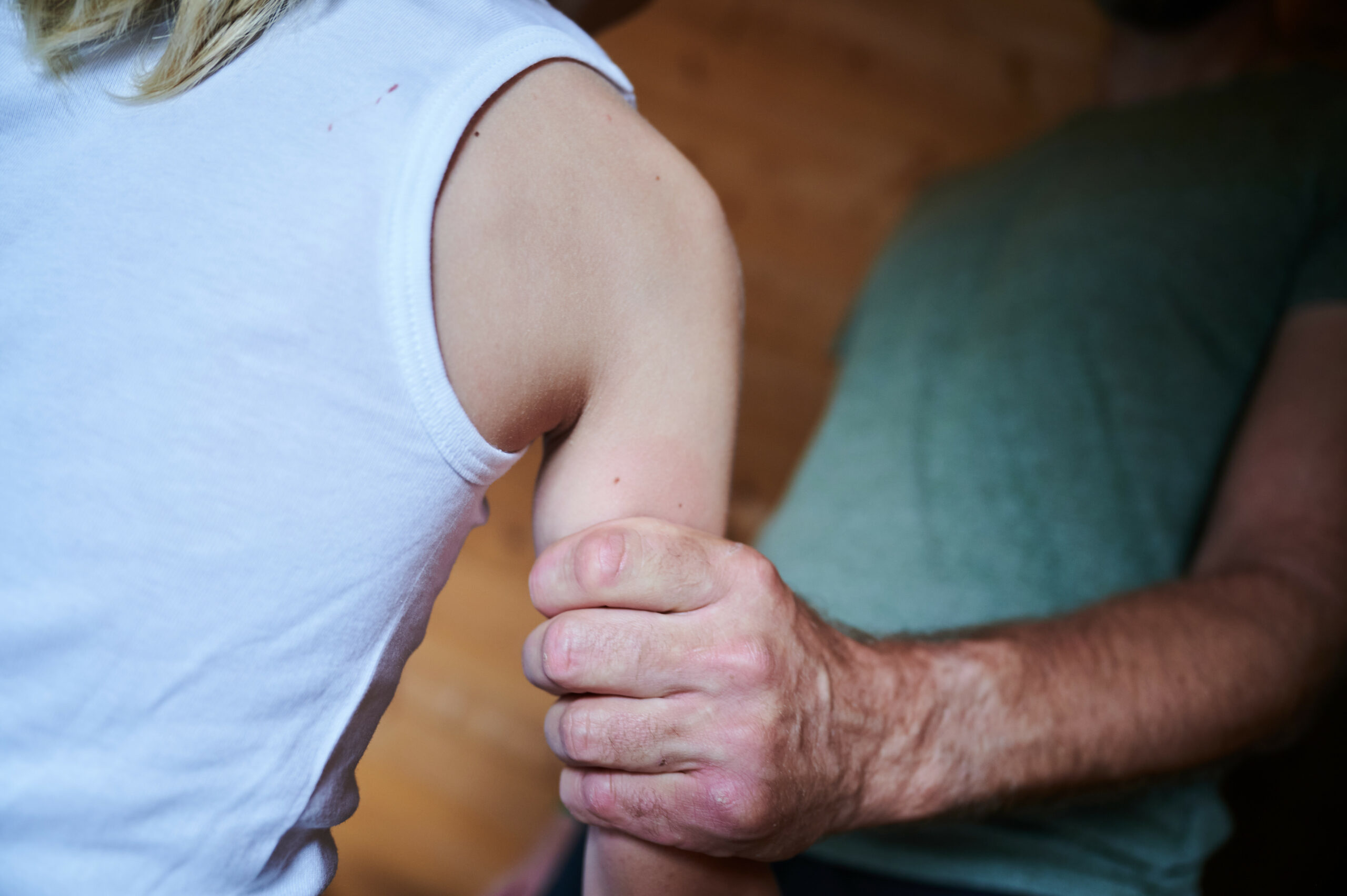 Mann packt Kind am Arm. (Symbolbild)