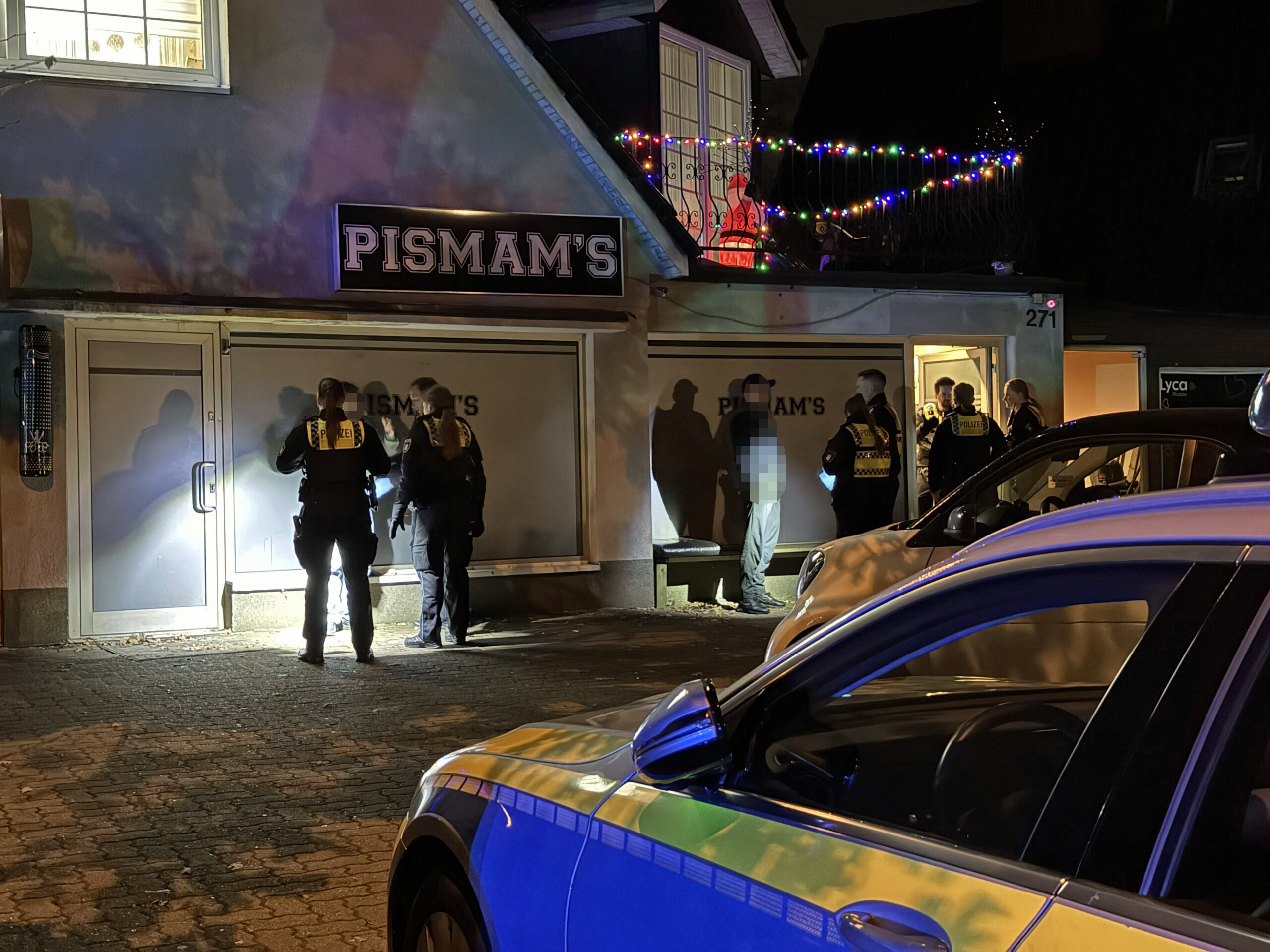 Polizisten stehen vor einer Shisha-Bar in Lurup.