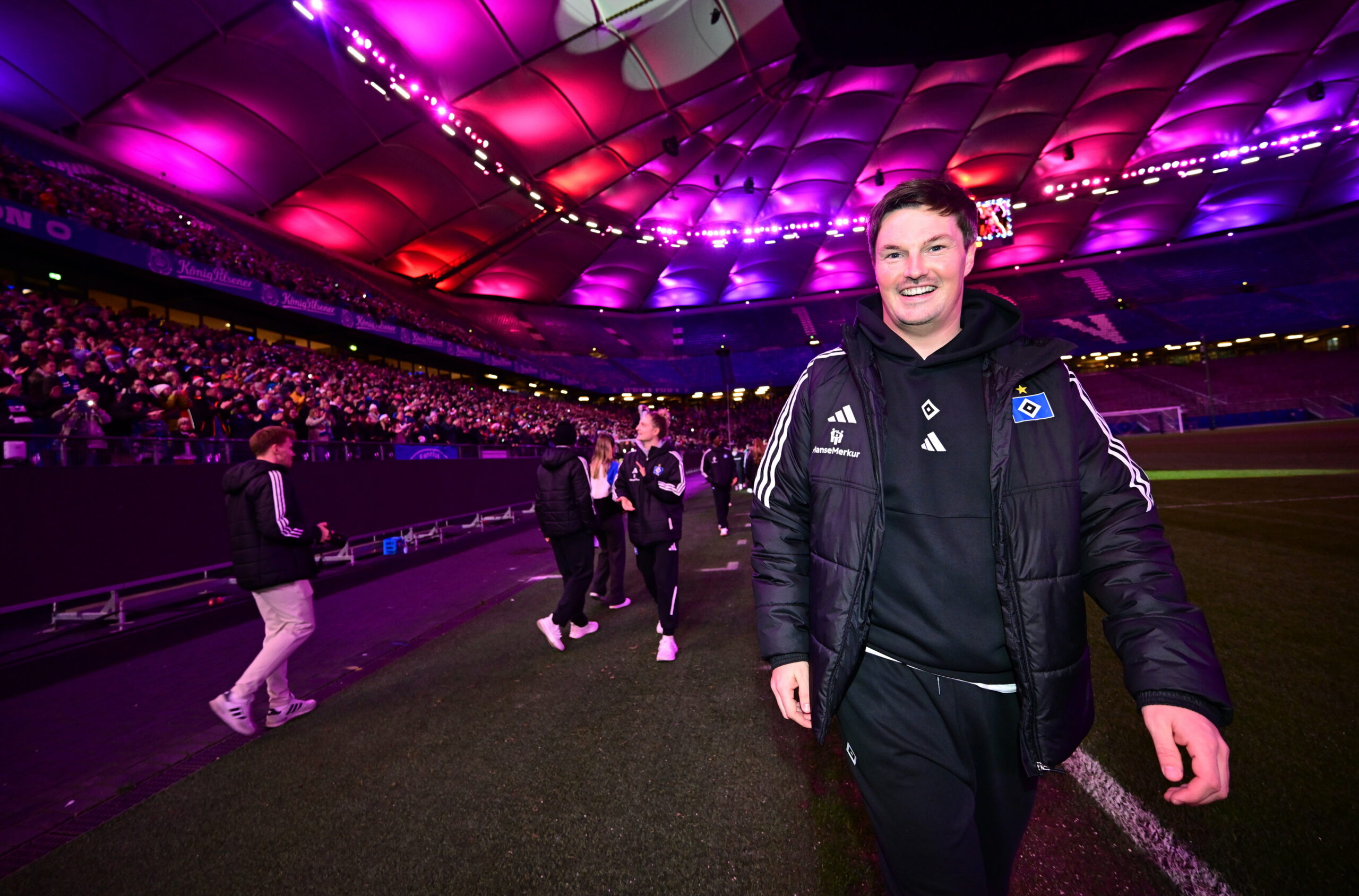 HSV-Trainer Merlin Polzin geht durch das beleuchtete Volksparkstadion