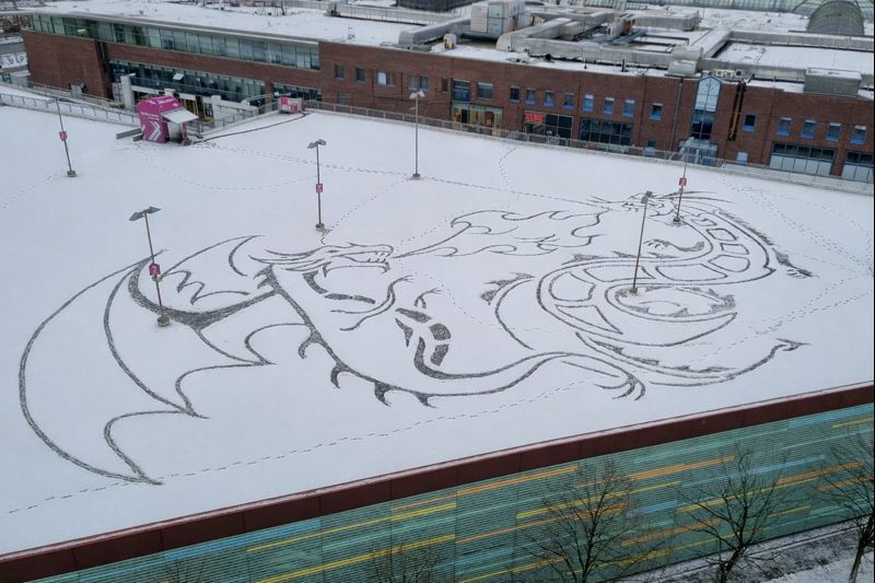 Auf dem Parkhausdach des Elbe-Einkaufszentrums in Hamburg-Osdorf hat ein Künstler mit seinen Füßen einen Drachen in den Schnee gezeichnet.