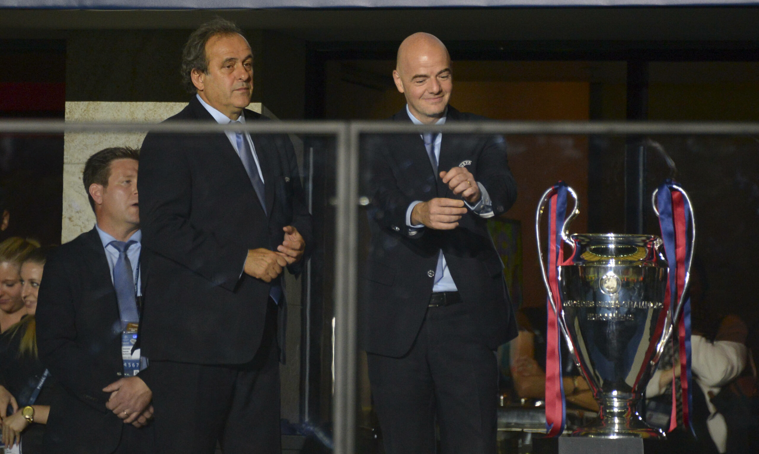 Michel Platini und Gianni Infantino stehen vor der Champions-League-Trophäe