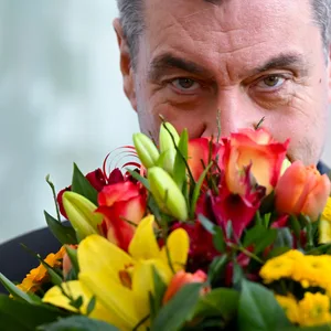 Markus Söder mit einem Bluemnstrauß