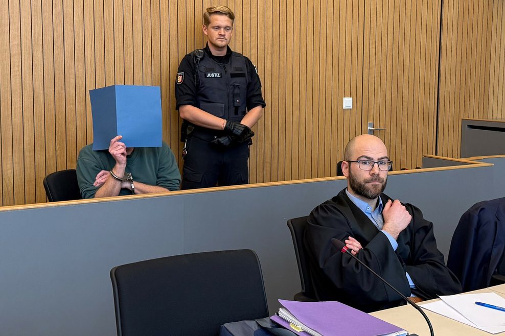 Der Angeklagte und sein Verteidiger Merlin Böttcher sitzen beim Prozess im Landgericht.