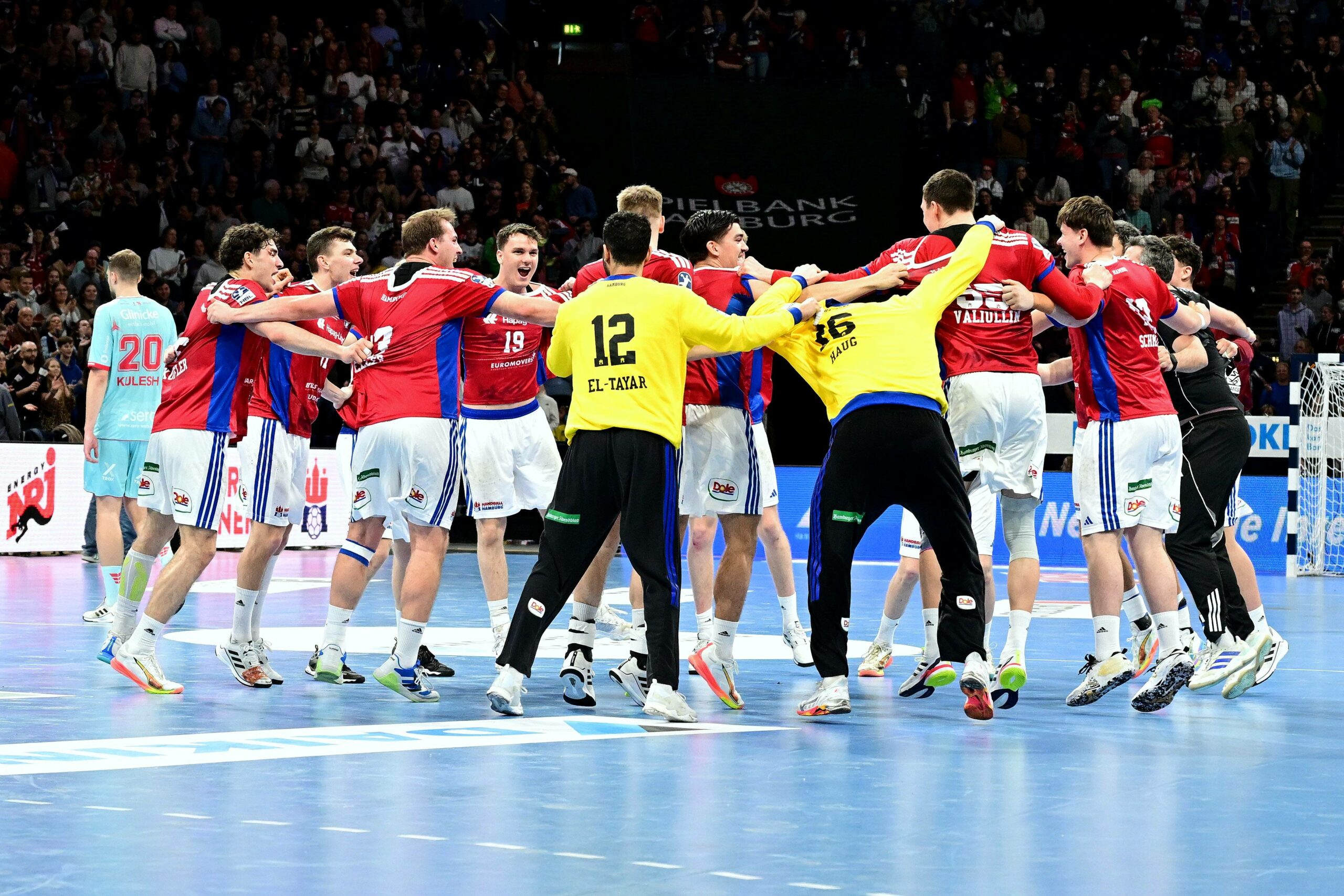 Die Spieler des HSVH feiern ihren Sieg über Melsungen.