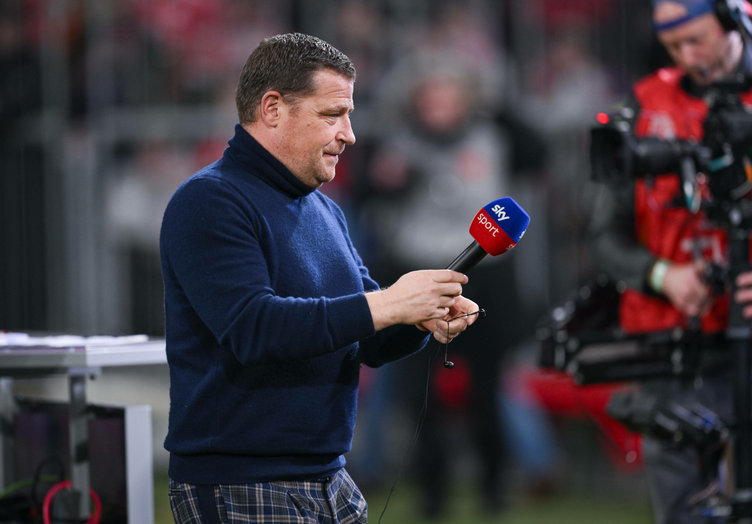 Max Eberl händigt ein Sky-Mikrofon aus.