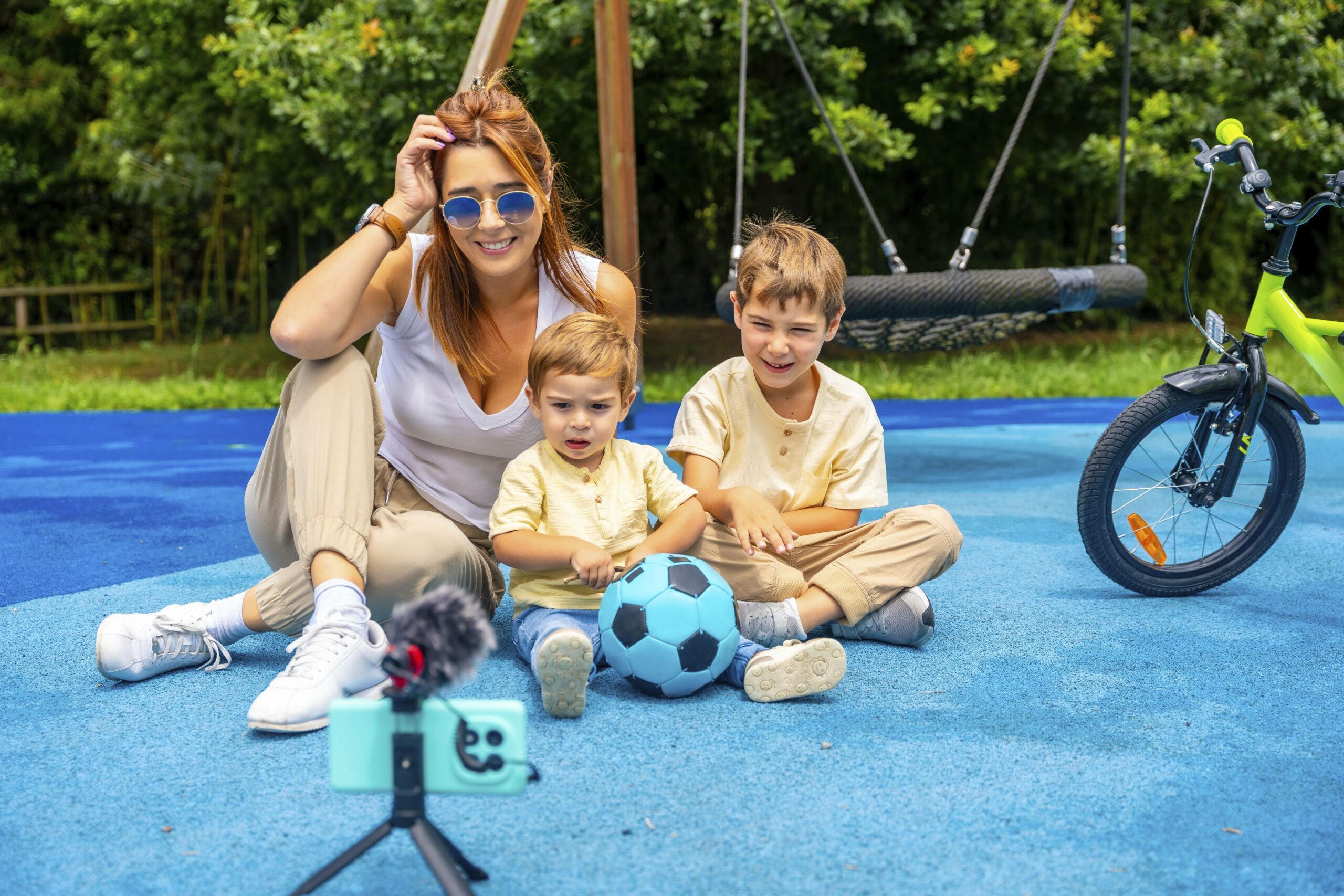 Mutter mit Kindern sitzt vor einem Smartphone