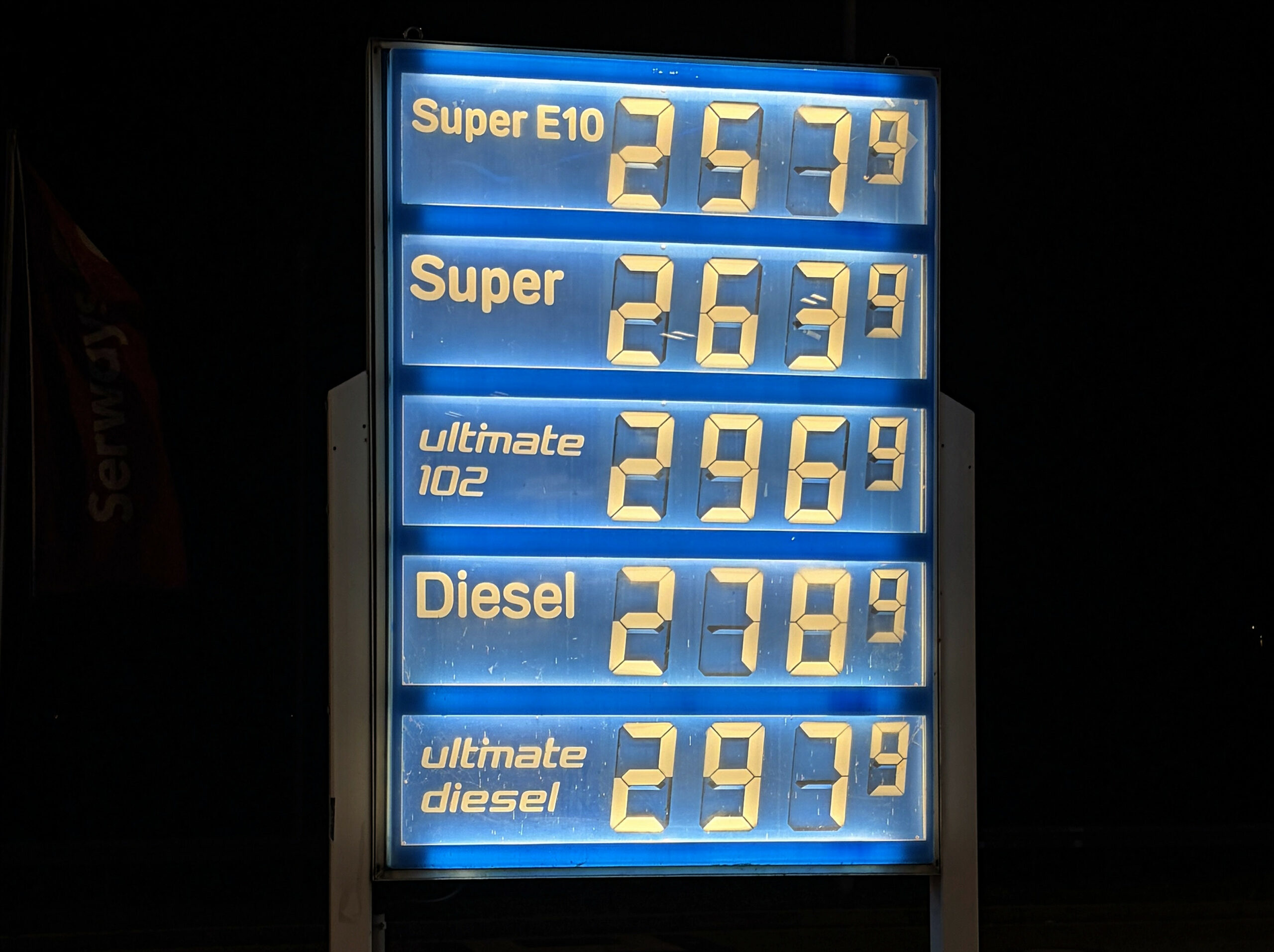 Spritpreise an einer leuchtenden Anzeige an einer Tankstelle.