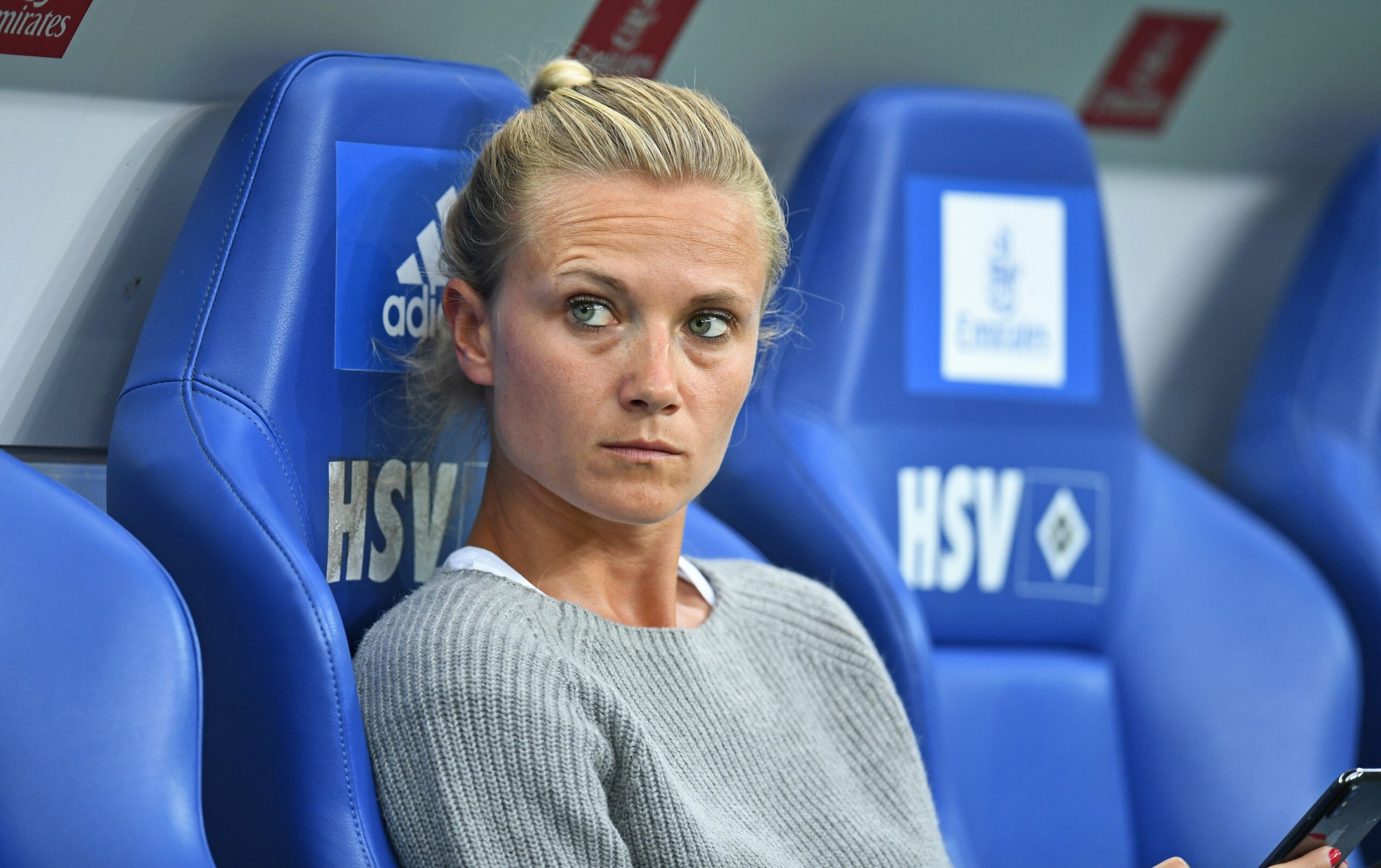 Kathleen Krüger sitzt 2018, vor dem Testspiel des FC Bayern beim HSV, auf der Ersatzbank.